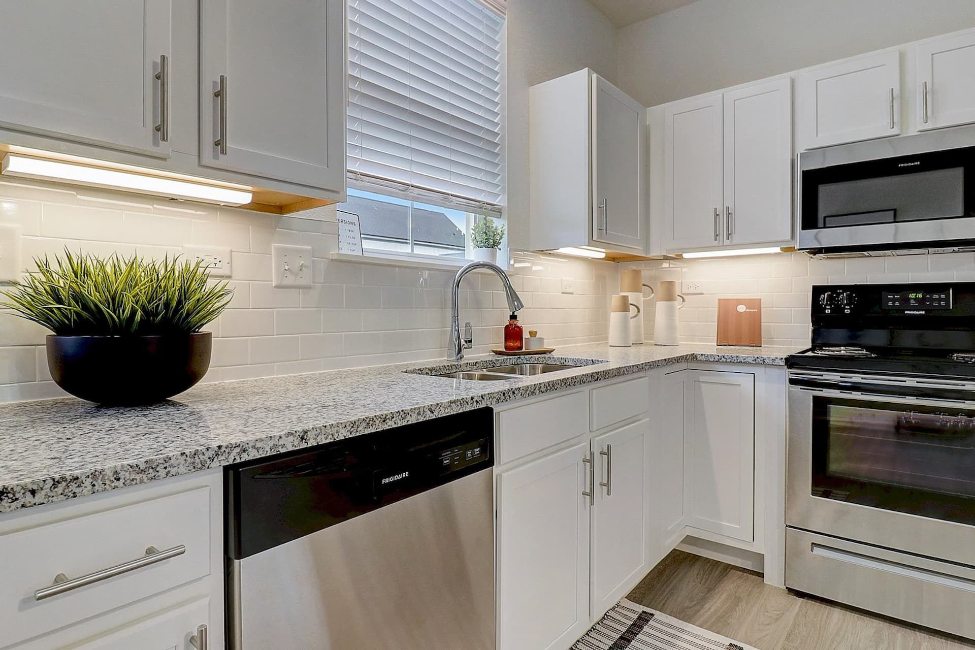 Stunning Kitchen with Granite and Stainless Steel Appliances at Avanterra Wolf's Crossing Single Family Home Rentals