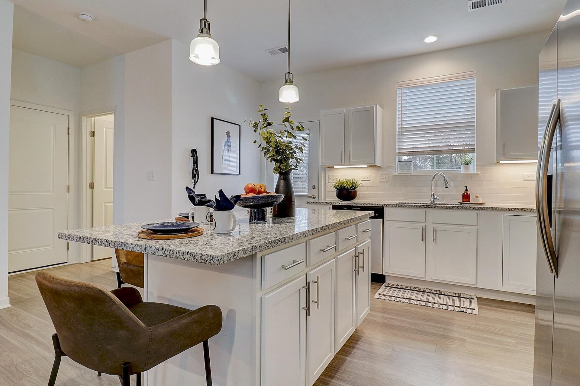 Stunning Kitchen with Granite and Stainless Steel Appliances at Avanterra Wolf's Crossing Single Family Home Rentals